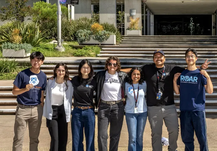 Seven Columbia Space Initiative members standing together outside a building at JPL